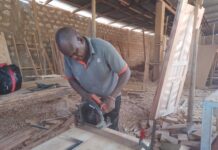 James Mua, disabled, showcases his skills in his workshop. James Mua specializes in boat making making him get money for his family who are disabled too .Photo Courtesy Teryani Mwadzaya