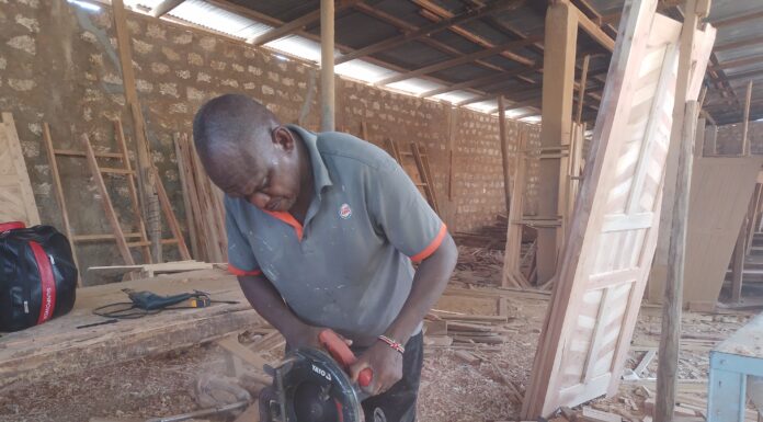 James Mua, disabled, showcases his skills in his workshop. James Mua specializes in boat making making him get money for his family who are disabled too .Photo Courtesy Teryani Mwadzaya