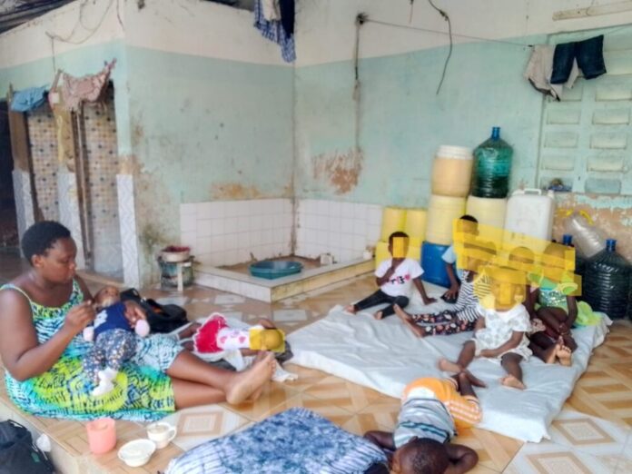 DINA koki with some of the children under her care