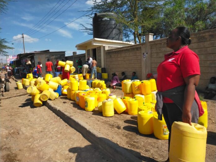 LONG WAIT AS RESIDENTS OF KITENEGELA QUEUE FOR CLAEN WATER AT A WATER KIOSK.PHOTO BY CHRISTINE WANGOI