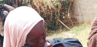 a woman in langas breastfeeding her baby