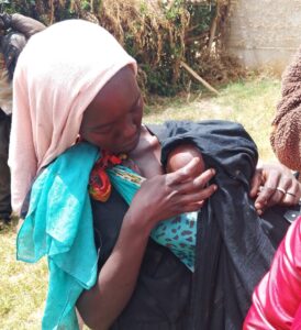 a woman in langas breastfeeding her baby