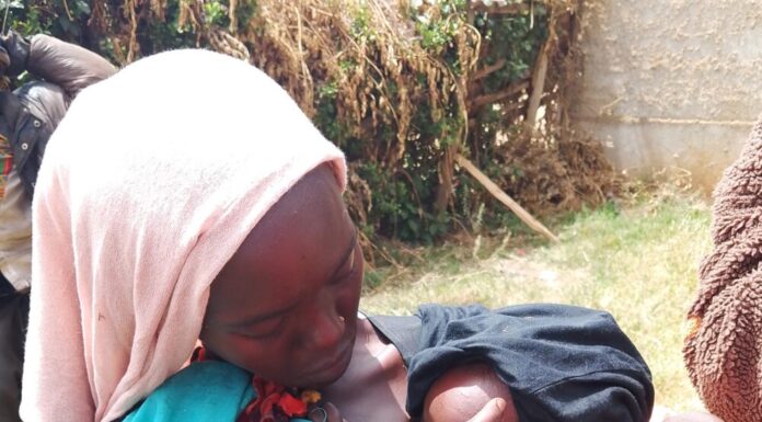 a woman in langas breastfeeding her baby